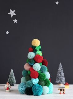 a christmas tree made out of pom - poms on top of a table