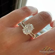 a woman's hand with a diamond ring on it