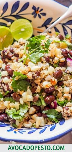 a bowl filled with rice, beans and cilantro on top of a table