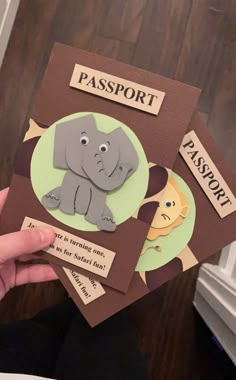 someone is holding up some cards with an elephant on them and the words passport are in front of them