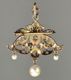 "This pendant is a great example of end of 19th century trend in jewelry. Elaborate design of the pendant incorporates total of 21 rose cut diamonds. The largest diamond, approx 5 mm across, set in crimped bezel mount in the center. The rose cut diamonds radiate a soft glitter under candle light of the ballrooms. Typically for the time the back of the pendant is gold and the front is sterling for better color fit to the diamonds especially with natural silver patina. The pendant would not be com Antique Gold Brooches With Rose Cut Diamonds, Antique Pendant Brooch With Intricate Design, Antique Brooch With Intricate Pendant Design, Ornate Gold Brooch With Rose Cut Diamonds, Ornate Gold Brooches With Rose Cut Diamonds, Antique Baroque Brooches With 17 Jewels, Victorian Jewelry With Historical Design For Evening, Victorian Gold Pendant Brooches, Victorian Diamond Filigree Brooches