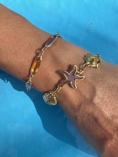 Gold beach bracelets like no other! Dive into luxury with our duo set, crafted with metal and enamel details on a stainless steel chain. One bracelet flaunts enamel bars, while the other features unique seashell charms for a truly distinct look. Wear them together or separately for a touch of beach glamour, exclusively at Christina Christi. 👉 My Women Bracelets Collection: https://etsy.me/2U57si7 👉 Express Shipping: https://etsy.me/3ikUnOM MATERIALS - Rectangular Enamels Bracelet: Metal Parts Bracelet Seashell, Beach Glamour, Wedding Sandals Heels, Flat Sandals Wedding, Seashell Bracelet, Bracelets Collection, Gold Beach, Beach Bracelet, Wedding Sneakers