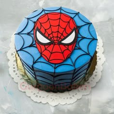 a spiderman cake on a white table