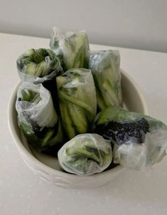 some food wrapped in plastic sitting in a bowl