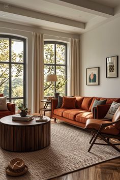 a living room filled with furniture and large windows