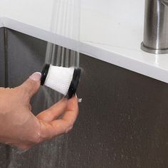 a person is washing their hands under a faucet