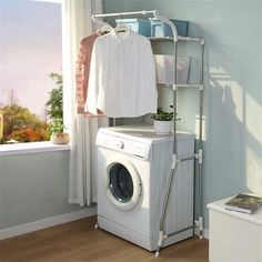 a washer and dryer sitting next to each other in front of a window