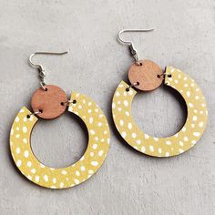 Add a touch of elegance to your outfit with our Beautiful Yellow Wood Circle Earrings. Crafted with care, these unique earrings are perfect for any occasion, featuring a soft and delicate yellow hue that adds a touch of femininity and sophistication to your look. 2 inches Handmade Yellow Drop Hoop Earrings, Yellow Dangle Hoop Earrings With Ear Wire, Yellow Single Dangle Earring, Single Yellow Dangle Earring, Trendy Yellow Drop Earrings, Yellow Drop Hoop Earrings As Gift, Trendy Yellow Earrings, Handmade Yellow Circle Earrings, Handmade Yellow Hoop Earrings