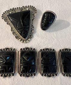 We have a rare gorgeous vintage silver black onyx Aztec jewelry set! The set comes with a brooch, ring, and bracelet, all stamped silver Mexico.  The set weighs together 5.8 ounces, the ring is roughly size 8. The band is a little bent unfortunately but still wearable. Please see attached photos for condition of the pieces. The set will need a goo polish and does have some markings/ scratched due to age of the set. The brooch size is 2 1/2 inches, the bracelet opened 7 1/2 inches long. Closed 3 Art Deco Black Engraved Jewelry, Vintage Silver Onyx Jewelry, Vintage Black Jewelry For Collectors, Antique Black Jewelry Stamped 925, Black Jewelry With Polished Finish For Collectible, Vintage Black Jewelry For Formal Occasions, Vintage Black Formal Jewelry, Vintage Silver Jewelry With Black Enamel, Handmade Vintage Onyx Jewelry