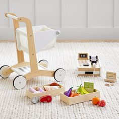 a baby's play set with wooden toys on the floor in front of it