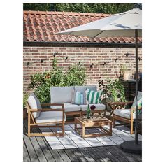 an outdoor patio with chairs, tables and umbrellas on the deck area next to a brick wall