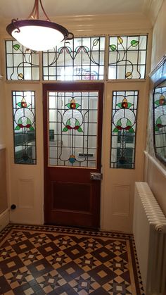 an entryway with stained glass windows and a radiator