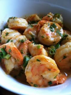 a white bowl filled with shrimp and vegetables