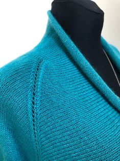 a blue sweater is shown on a mannequin's dummy head and neck