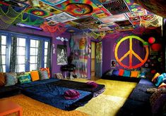 a bedroom decorated in bright colors with peace signs on the ceiling and rugs covering the floor