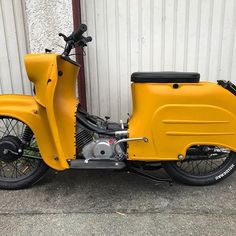 a yellow motorcycle parked next to a building