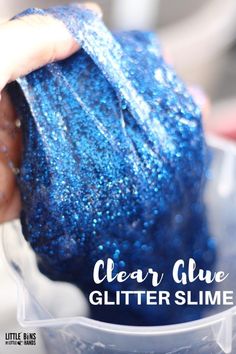 someone is holding a blue glitter slime in their hand and the text clear glue glitter slime on it