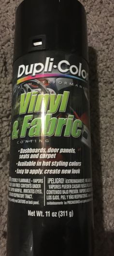 a can of vinyl and fabric cleaner sitting on the floor in front of carpeting