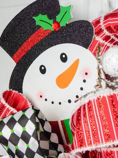 a close up of a snowman decoration on a door