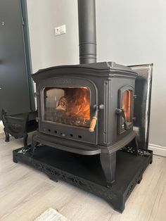 a wood burning stove sitting on top of a hard wood floor