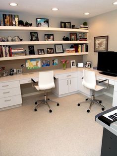 a home office with two white chairs and a piano in the middle of the room