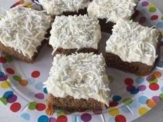 several pieces of cake on a plate with white frosting and sprinkles