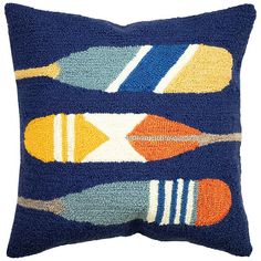 a blue pillow with multicolored kayaks on the front and back, sitting on a white background