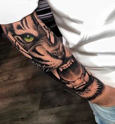 a man's arm with a tiger tattoo on it and an eye in the middle