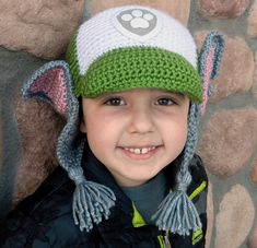 a young boy wearing a crocheted hat with ears