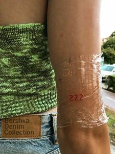 a woman's arm covered in plastic wrap with the number 22 printed on it