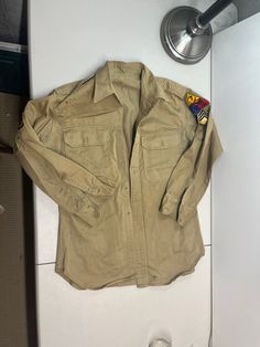 "Used acceptable condition military style khaki Shirt. Missing buttons and needs to be cleaned. Shoulder to shoulder: 18\" Pit to Pit: 21\" Length:  27\"." Khaki Collared Utility Shirt, Khaki Military Collared Shirt, Khaki Collared Military Shirt, Utility Style Khaki Tops With Buttons, Khaki Utility Tops With Buttons, Military Style Long Sleeve Shirt With Buttons, Khaki Shirt, Military Style, Mens Oxfords