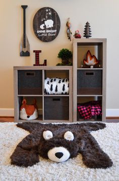 a stuffed animal is on the floor in front of a shelf with drawers and other items