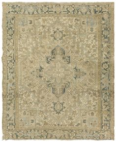 an antique rug with green and beige colors