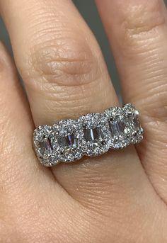 a woman's hand with a diamond and white gold ring on top of it