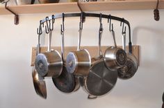 pots and pans are hanging on the wall