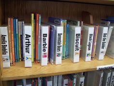 books are lined up on a book shelf