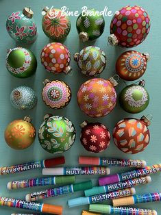 many different colored ornaments and crayons on a table