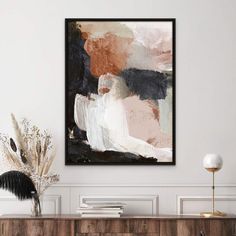 an abstract painting hangs on the wall above a dresser