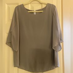 Gray, Long Sleeve Blouse. Made Of Polyester And Rayon With A Small Amount Of Spandex. Dressy. Gray Stretch Summer Blouse, Gray Stretch Blouse For Summer, Stretch Summer Blouse In Gray, Stretch Gray Summer Blouse, Elegant Gray Stretch Top, Elegant Gray Short Sleeve Tops, Short Sleeve Stretch Blouse For Layering, Stretch Short Sleeve Blouse For Layering, Three Quarter Sleeve Blouses