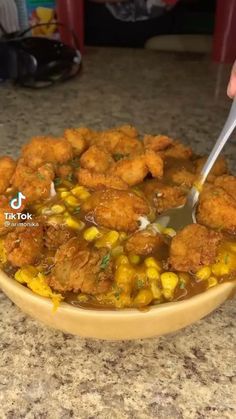 a bowl filled with fried corn and sauce