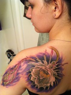 a woman with a flower tattoo on her shoulder