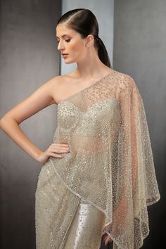 Mist saree gown with all-over sequins embroidery.
Component: 1
Pattern: Embroidered
Type Of Work: Sequin
Neckline: One Shoulder
Sleeve Type: Sleeveless
Fabric: Tulle
Color: Beige
Other Details: 
Strappy back blouse
Sheer panels
Closure: Back zipper
Occasion: Cocktail - Aza Fashions Saree Gowns, Rahul Khanna, Gown For Women, Saree Gown, Embroidered Saree, Indian Couture, Gowns Online, Sequins Embroidery, Sheer Blouse