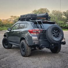 the back end of a gray subarunt parked in a parking lot