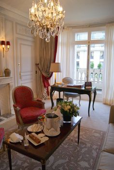 a living room filled with furniture and a chandelier