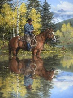 a man riding on the back of a brown horse next to a forest filled with trees