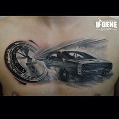 a man's chest with a car and tire tattoo on it