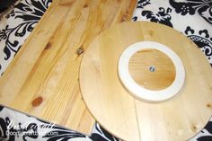 a wooden toilet seat sitting on top of a black and white blanket