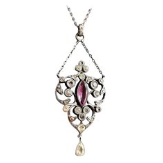 A stunning Antique Edwardian era, Belle Epoque sterling silver paste pendant necklace. It has a large pretty lavalier style pendant drop suspended from a small length of chain set with old diamond paste stones and a single Amethyst paste, the pendant has a further drop suspended from the base giving it lots of movement and sparkle. The main pendant is attached to a paste jeweled bale on the original fine link sterling silver chain. It has a spring ring fastener. A truly stunning piece of antique Victorian White Gold Pendant Necklace, Antique White Gold Pendant Necklace, Antique White Gold Necklace With Pearl Pendant, Art Deco White Gold Necklace With Rose Cut Diamonds, Silver Diamond Drop Necklace With 17 Jewels, Vintage Diamond Gemstone Necklace, Vintage Diamond Necklace With Gemstones, Antique White Gold Necklace With Large Pendant, Victorian Engraved Diamond Necklace