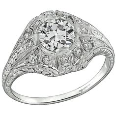 Handcrafted from the Art Deco era, this ring is centered with a sparkling GIA certified circular brilliant cut diamond that weighs 0.93ct. graded J color with VS2 clarity. The center diamond is accentuated by dazzling round cut diamond accents. The top of the ring measures 12mm by 16mm. It is currently size 7 3/4, and can be resized. Inventory #89708ARSS Luxury Antique Diamond Ring With Vvs Clarity, Luxury Antique Ring With Brilliant Cut, Vintage Silver Gia-certified Diamond Ring, Antique Diamond Cut Filigree Ring As Gift, Antique Diamond Filigree Ring Collectible, Platinum Engagement Ring, Platinum Diamond Engagement Rings, Platinum Engagement Rings, Art Deco Engagement Ring