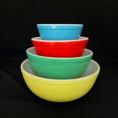 four colorful bowls stacked on top of each other